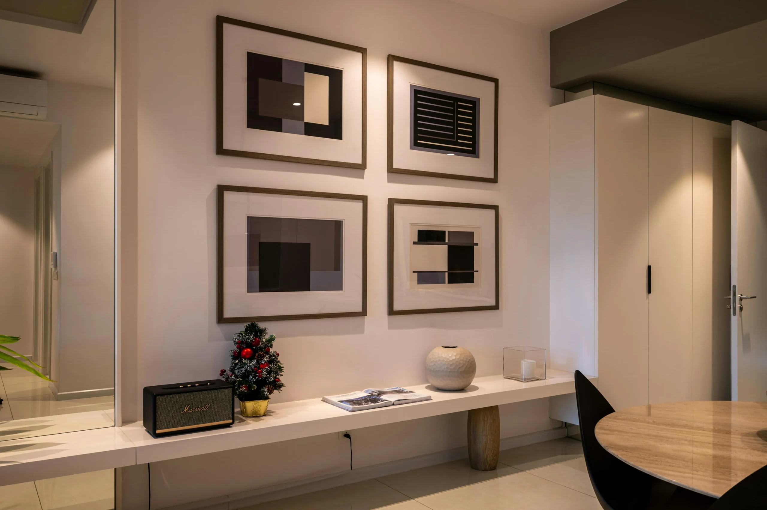 A calm living room with artwork placed at eye level.