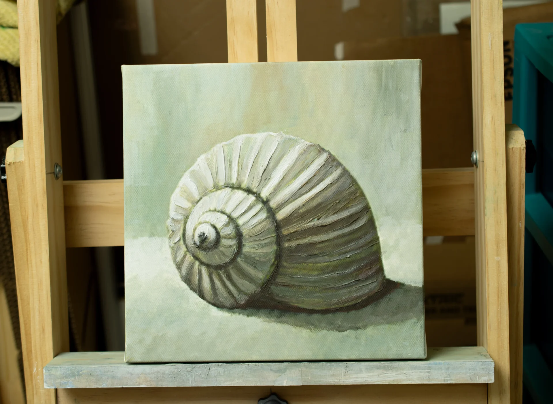 A quiet studio with an easel holding a painting in progress, surrounded by brushes and natural light.