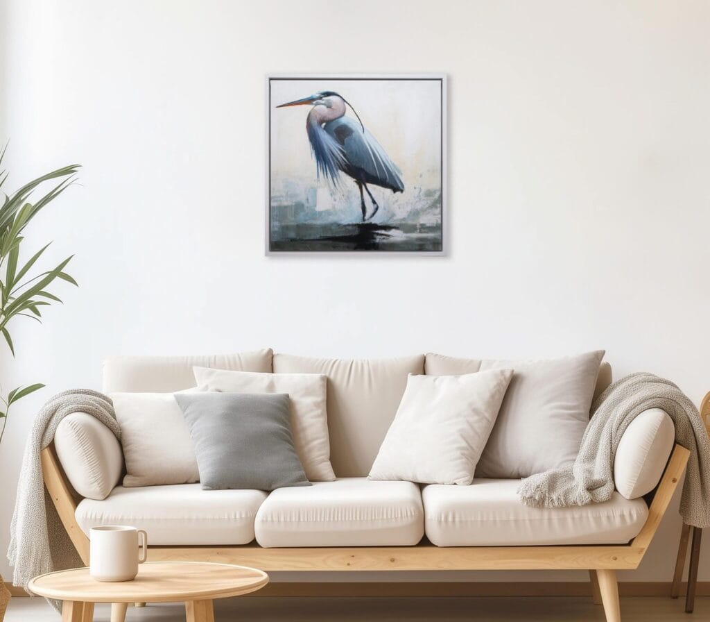 Blue Heron Poise limited edition bird artwork displayed above a neutral living room sofa by Bonum Art Gallery