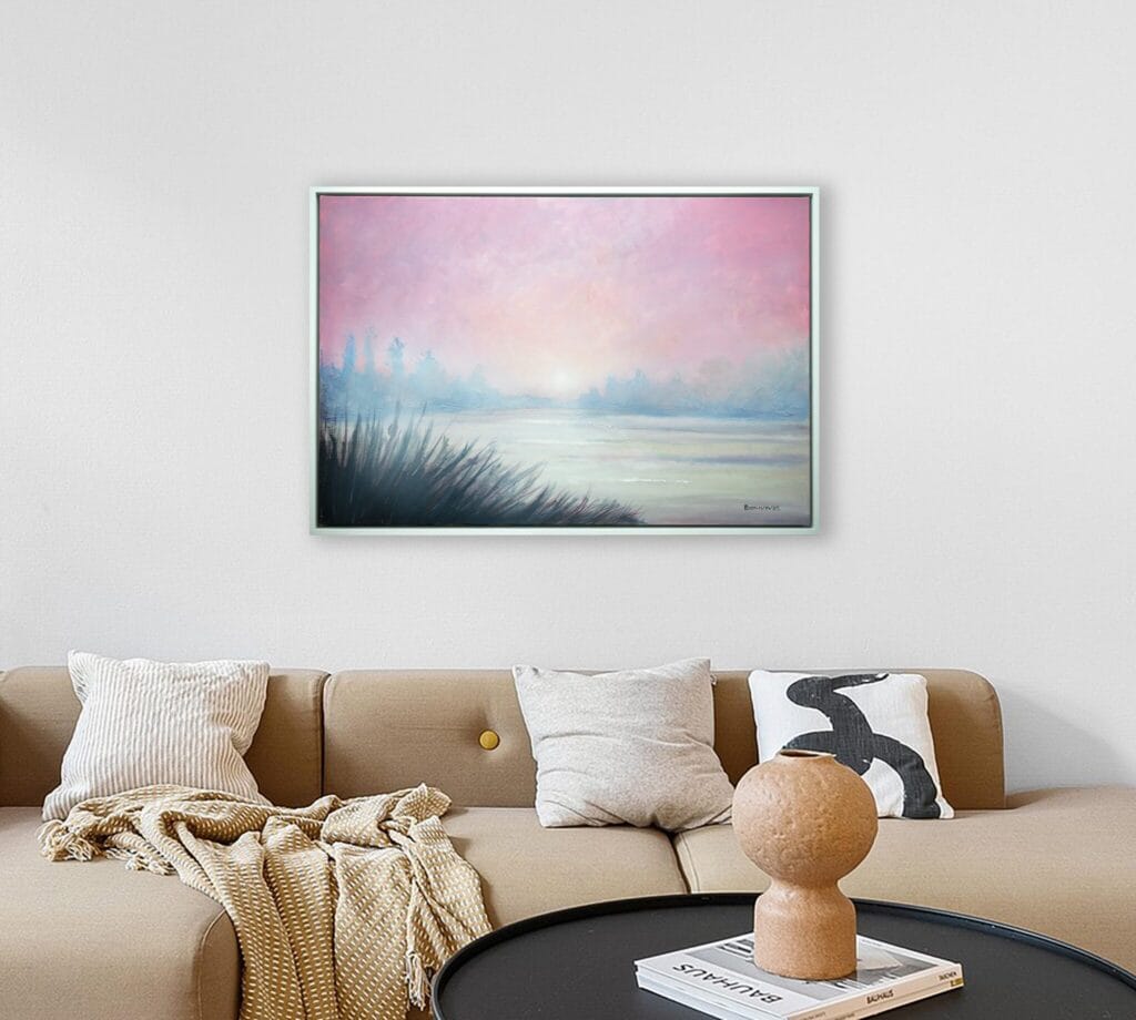 Blush of Morning original framed artwork displayed above a sofa in a softly styled living room.