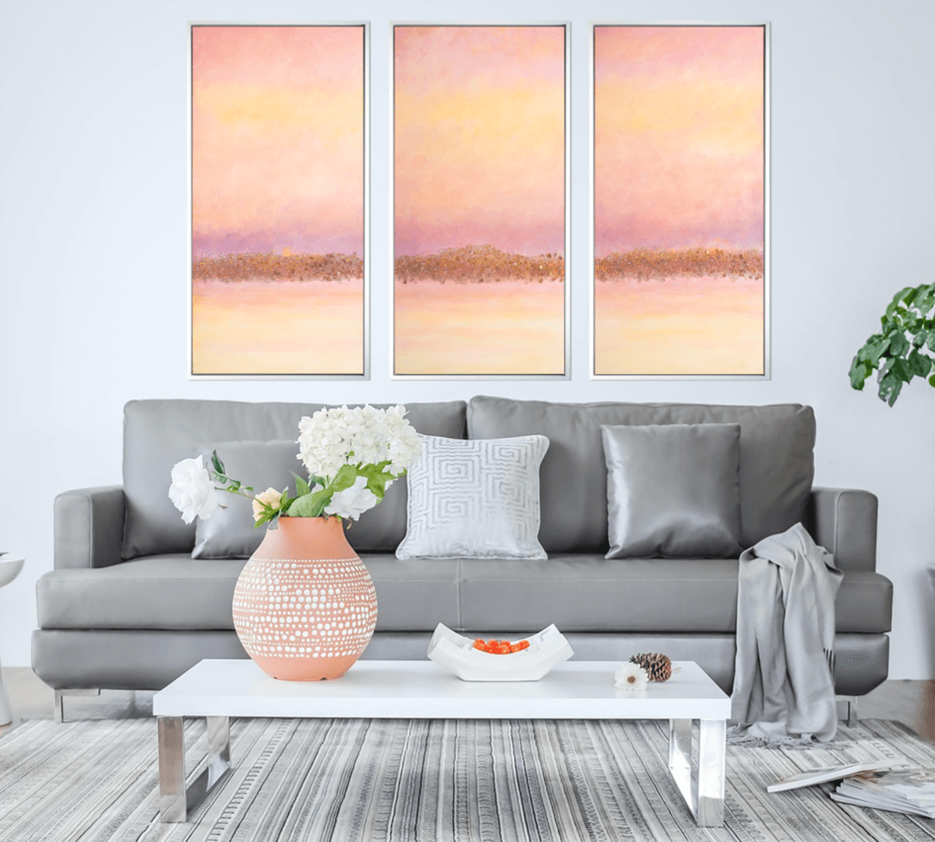 Dawnlight Reflections original acrylic triptych displayed above a gray sofa in a bright contemporary living room.
