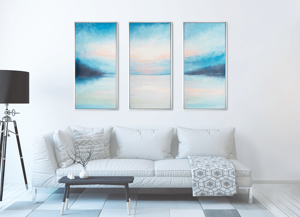 Ethereal Horizon Symphony original three-panel acrylic artwork displayed above a white sofa in a bright modern living room.