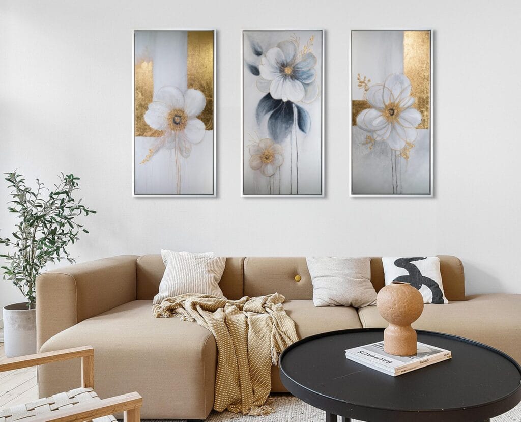 Golden Bloom Symphony original three-panel floral artwork displayed above a beige sofa in a warm contemporary living room.
