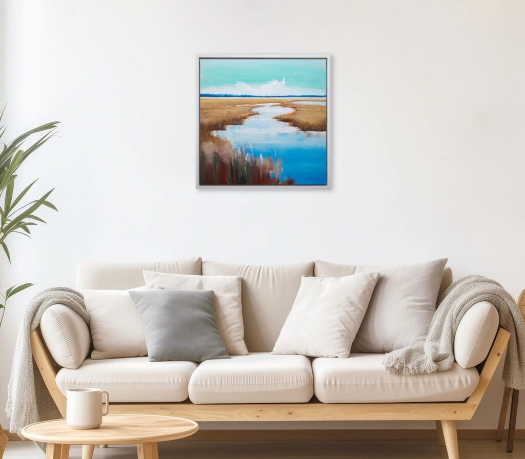 Golden Marsh Path original framed acrylic painting displayed above a sofa in a calm contemporary living room.
