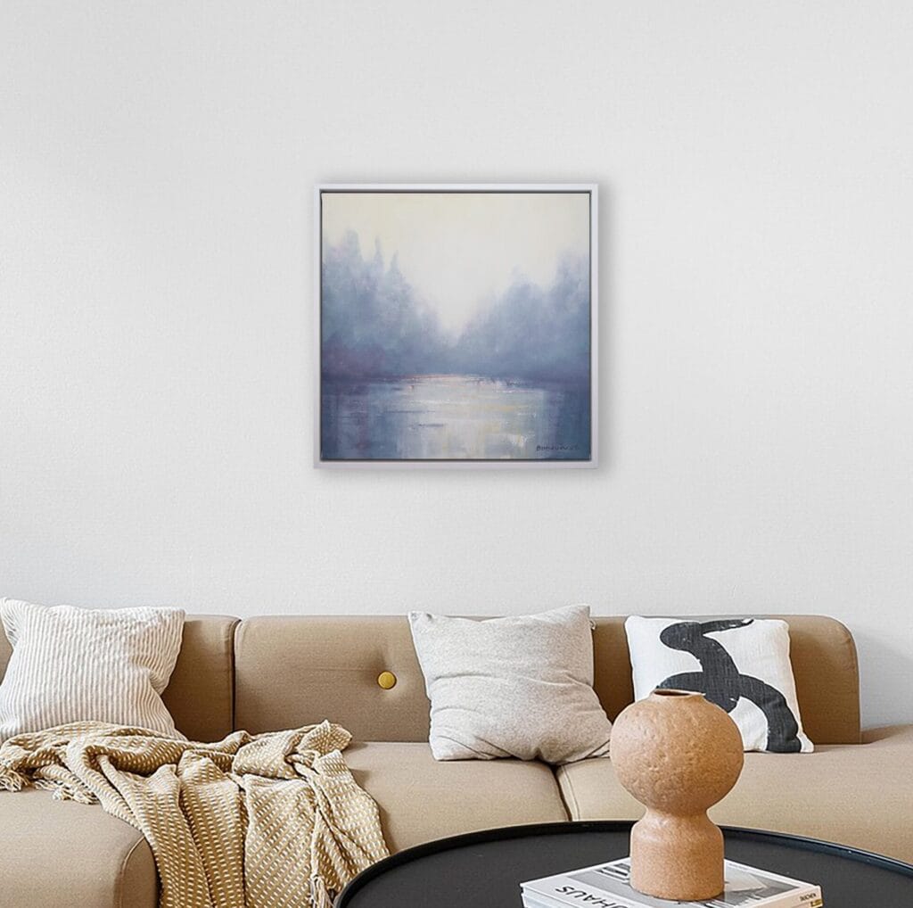 Misty Dawn original framed artwork displayed above a sofa in a soft neutral living room.