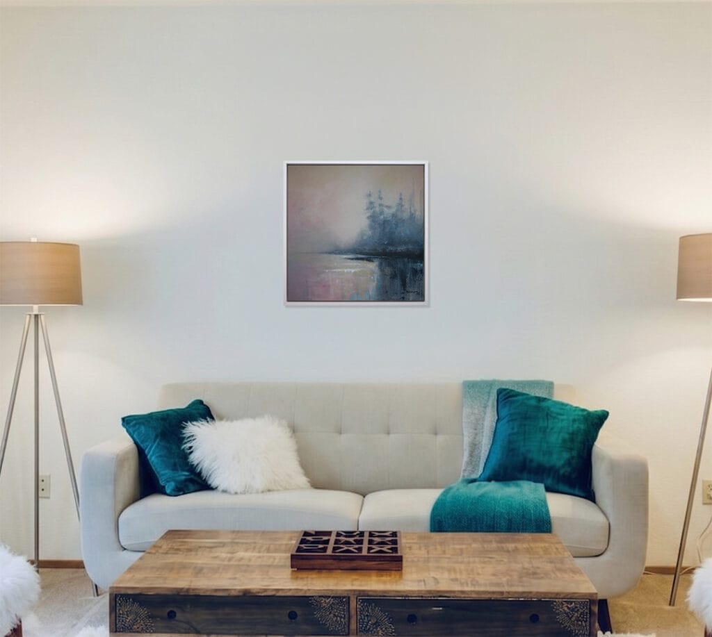 Horizon Mist original framed artwork displayed above a sofa with blue-green accent pillows in a contemporary living room.