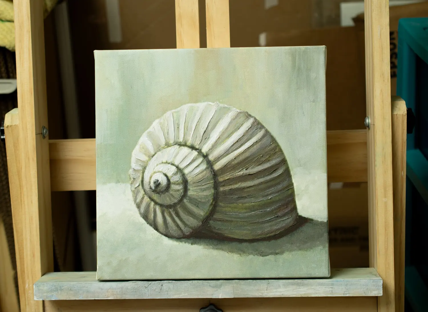 Shell painting resting on an easel during studio observation